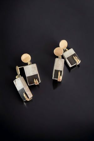 two pair of art deco earrings made from elk antler and bison horn. set in sterling silver and raw brass.